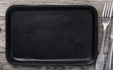 Cutlery and cast iron baking sheet with copy space. Food background, top viewの写真素材