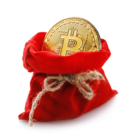 Bitcoin in a red bag as a New Years gift isolated on a white backgroundの写真素材