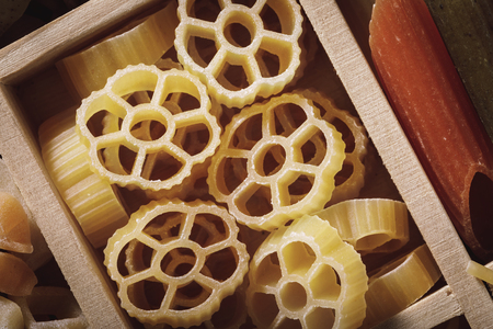 Closeup of pasta in a wooden box, top viewの写真素材