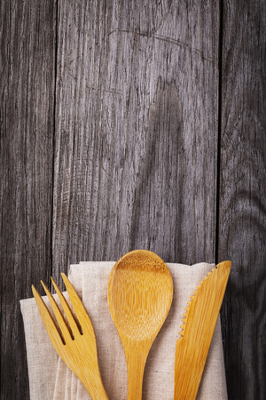Cutlery and napkin on a wooden table with copy spaceの写真素材