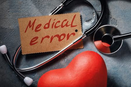 Medical error concept: stethoscope and heart shaped object, close-up