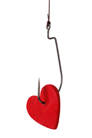 Red heart on a hook isolated on white background. Concept for lovers dayの写真素材
