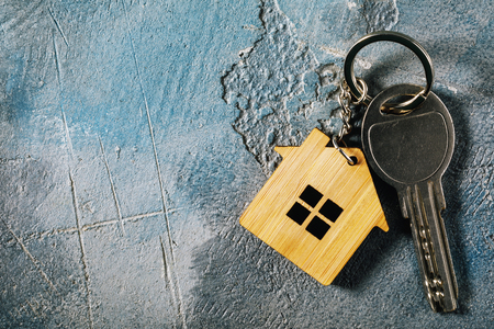 Keys to the apartment on the table with copy space, top viewの写真素材