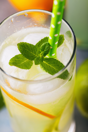 Invigorating tonic with lemon, lime and mint in a clear glass, close-upの写真素材