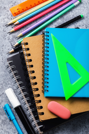 Various school supplies on the desk. Top view on pencils, notebooks and moreの写真素材