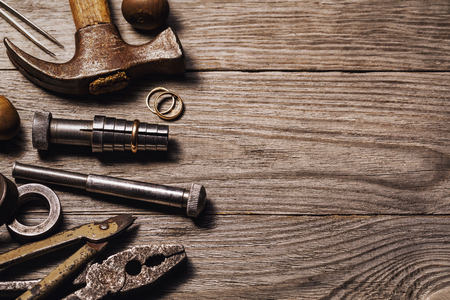 Tools for the repair of jewelry on a wooden table with copy space, top viewの写真素材