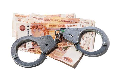 Handcuffs on russian rubles isolated on white background. Concept on the subject of currency fraudの写真素材