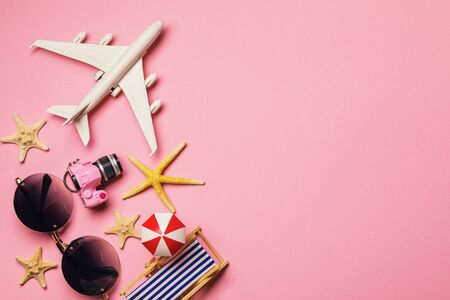 Beach accessories on a pink background with copy space, top view. Vacation Theme Templateの写真素材