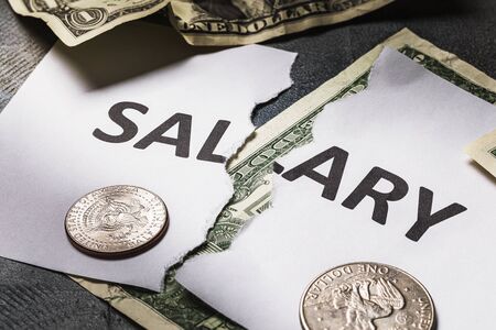 The inscription salary is torn in half. Concept on the financial crisis. There will be no salary