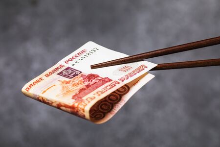 Chinese sticks hold rolled up five thousand rubles.の写真素材