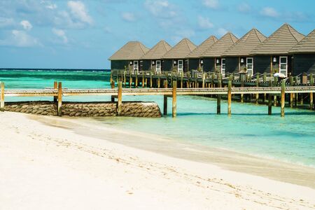 Bungalow by the ocean. White sand beachの写真素材