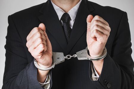 Handcuffed deputy, close-up. Concept on the topic of arrest for corruptionの写真素材