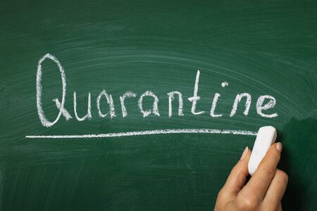 The teacher left a message for the students with chalk on the blackboard. School quarantine conceptの写真素材