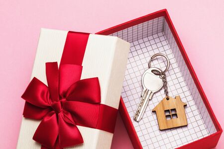 House key in a box on a pink background. Real estate gift conceptの写真素材