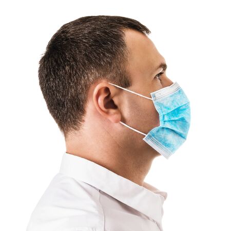 Man in medical mask blue isolated on white background, side viewの写真素材