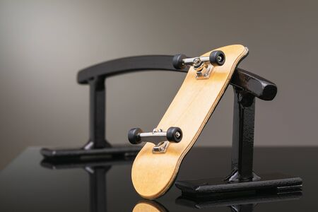 Fingerboard on a metal railing of black color, close-upの写真素材