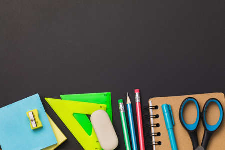 Various school supplies at the bottom of the table with copy space, top viewの写真素材