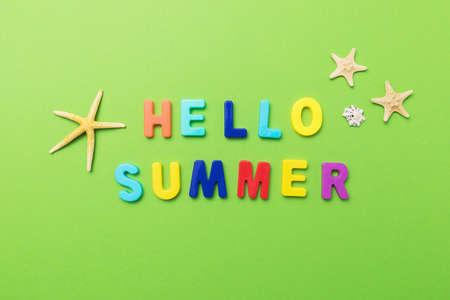 The inscription from multi-colored plastic letters with starfish on a green background.の写真素材