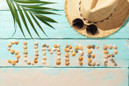The inscription from seashells on a wooden background, hat and sunglasses, summer backgroundの写真素材