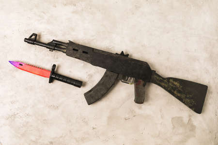 Toy machine gun and bayonet knife made of wood, top view