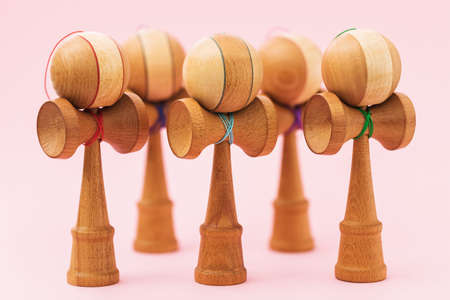 Five Japanese wooden Kendama toys on a pink backgroundの写真素材
