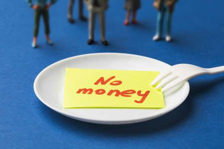 Sticker with text in a plate on a blue background, the concept of people having no money for foodの写真素材