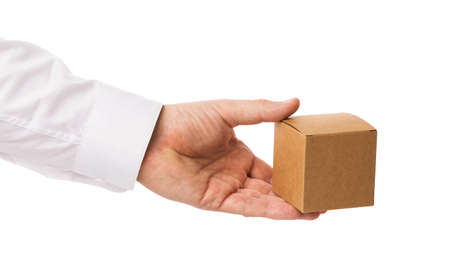 Man holds in hand a cardboard box isolated on white background, template for designers