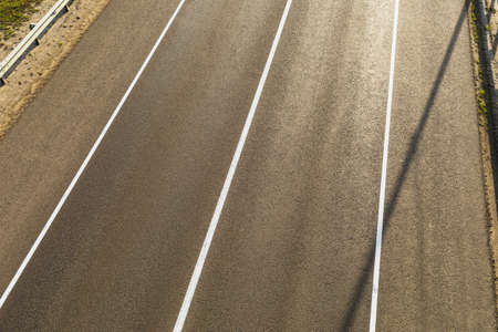 Two-lane asphalt road background, top view