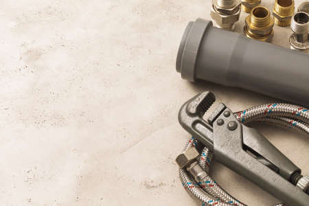 Various plumbing tools with copy space, gas adjustable wrench, pipe, adapters and flexible hoses