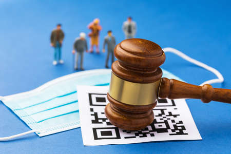 Judge gavel, barcode, medical mask and plastic toy men, the concept of administrative punishment for...