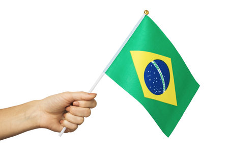 Hand holds Brazilian flag isolated on white background, template for designersの写真素材
