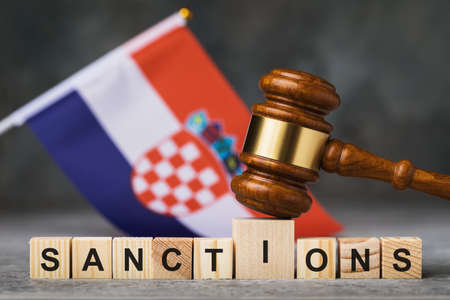 Judge gavel, wooden cubes with the text on the background of the Croatian flag, the concept on the theme of sanctions in Croatiaの写真素材