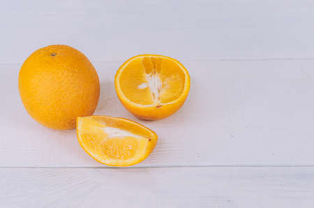 Fresh tropical oranges on a light background