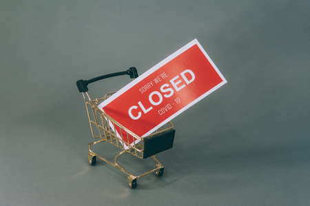 Red plate Sorry We're Closed COVID-19 with a supermarket trolley on gray backgroundの写真素材