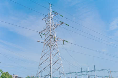 Pillar with electric wires against the skyの写真素材