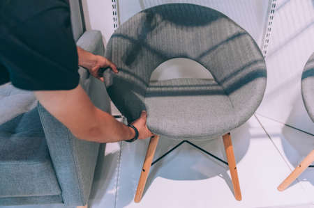 Buyer chooses a chair for home in a supermarketの写真素材