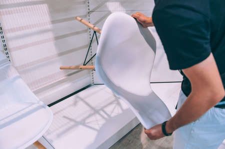 Buyer chooses a chair for home in a supermarketの写真素材