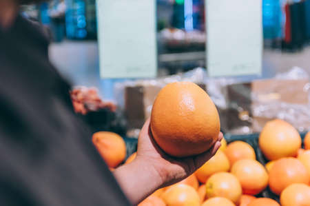 A box of fresh oranges in a supermarketの写真素材