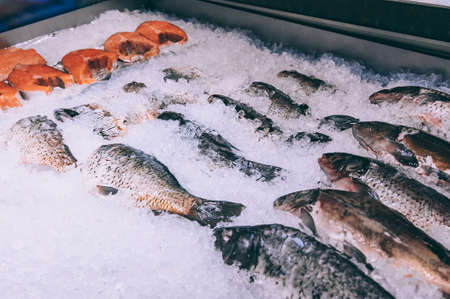 Fish with ice in the refrigerator in the supermarketの写真素材