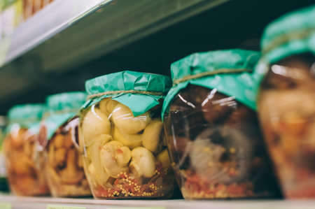 Mushrooms in a glass jar on the counterの写真素材