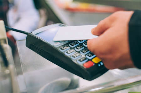 A man pays for purchases with a credit cardの写真素材