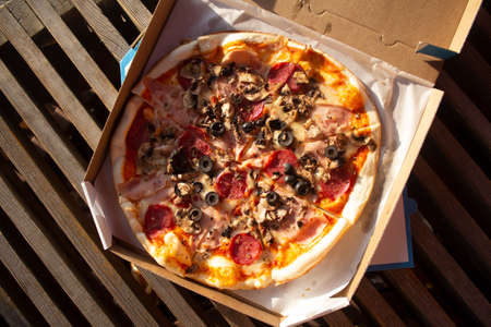 Pizza in a box close up. Fast food in the fresh airの写真素材