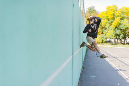 The guy is dancing against the blue wallの写真素材