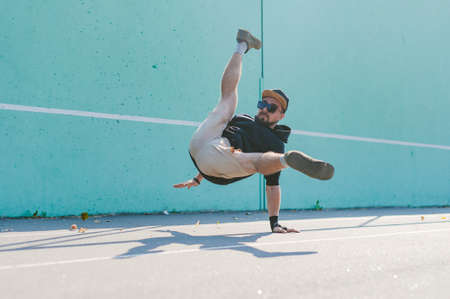 Bboy dancing breakdance against a blue wallの写真素材