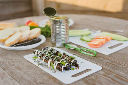 Fresh vegetables with salad and grilled sausages on a wooden table backgroundの写真素材