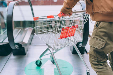 The guy is holding a supermarket trolleyの写真素材