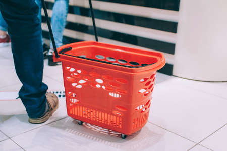 The guy is holding a supermarket trolleyの写真素材
