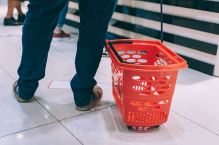 The guy is holding a supermarket trolleyの写真素材