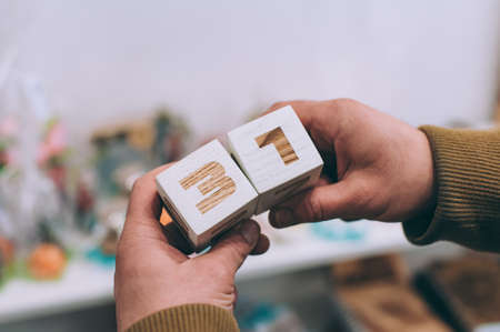 The guy is holding calendar cubes with 31 numbersの写真素材