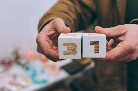 The guy is holding calendar cubes with 31 numbersの写真素材